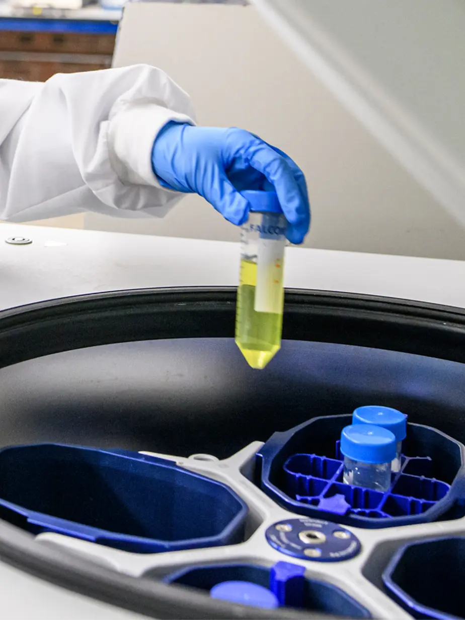 Founder showing extracted-metals samples to a corporate partner